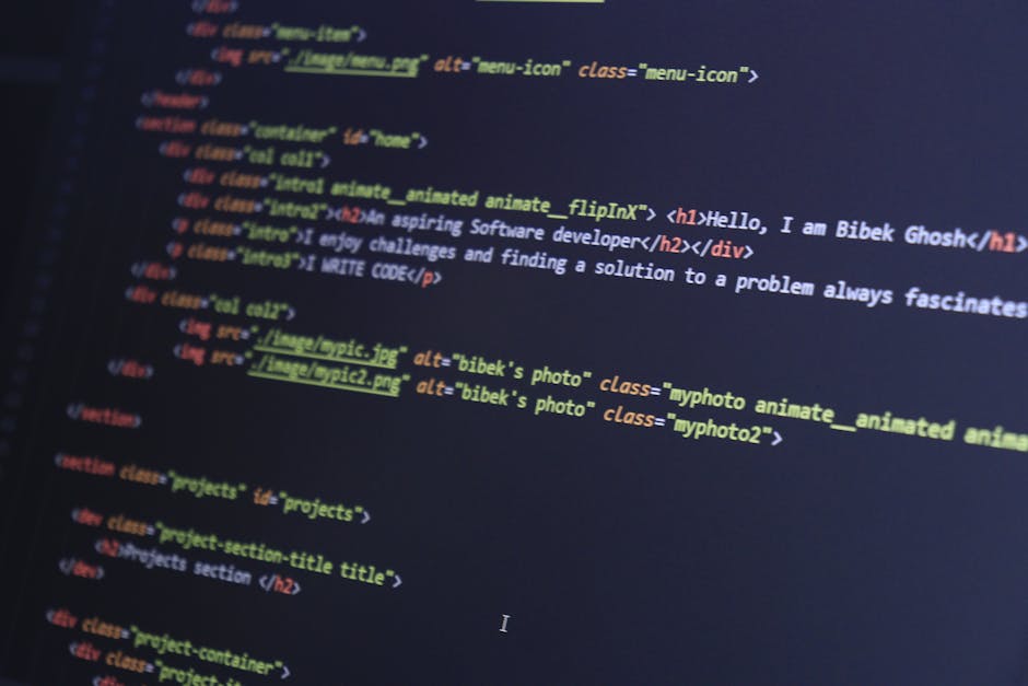 A close-up photograph of a computer screen displaying lines of colorful programming code, with a mix of syntax highlighting in red, green, yellow, blue, and white, showing various functions, variables